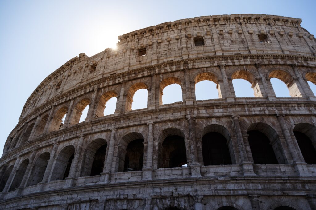 A low angle shot of the famous Colosseum in Rome, Italy under the bright sky